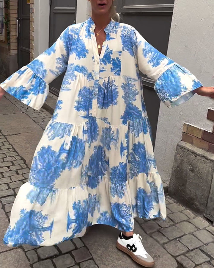 Woman wearing the Abigail flowing maxi dress with a delicate print and V-neckline, the skirt moving softly as she walks.