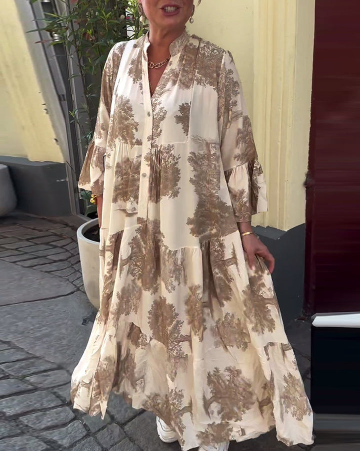 Woman wearing the Abigail flowing maxi dress with a delicate print and V-neckline, the skirt moving softly as she walks.