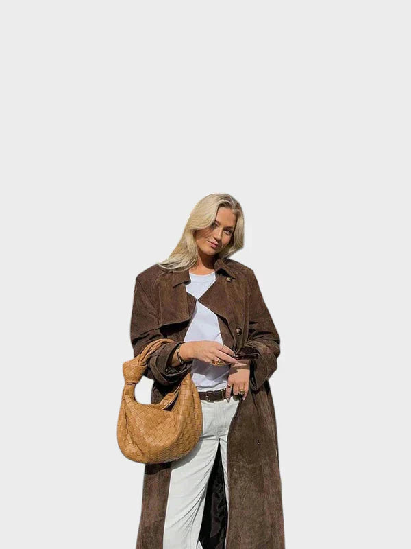 Classic belted trench coat in rich brown with a flowing, tailored silhouette and elegant collar
