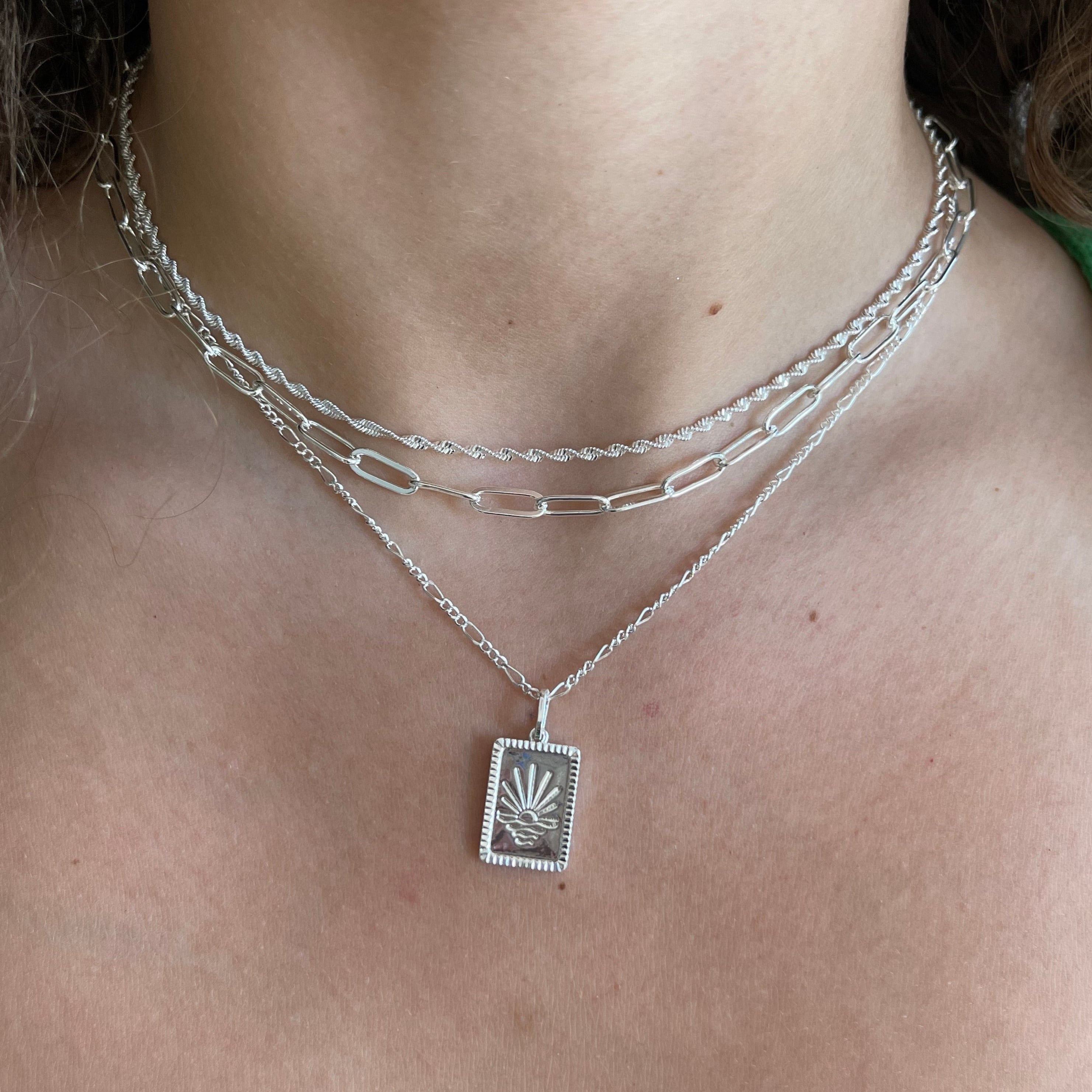 Gold radiant sun pendant necklace on fine polished chain