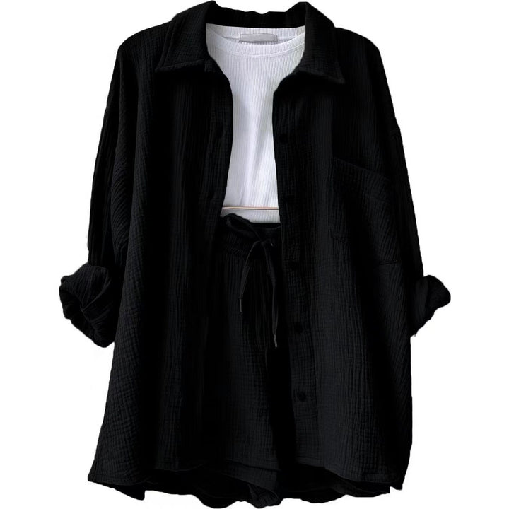 A woman wearing a relaxed button shirt with matching drawstring shorts, fresh and easy.