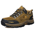 Men's khaki outdoor hiking boot with a rugged sole and lace-up front on a trail setting
