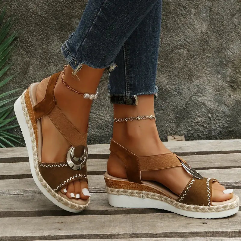 Gold platform sandals with metallic detail and ankle strap