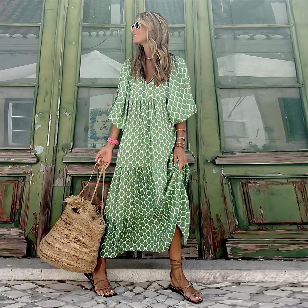 A woman wearing the Concepta spring print dress in green and pink tones, styled for a day out.