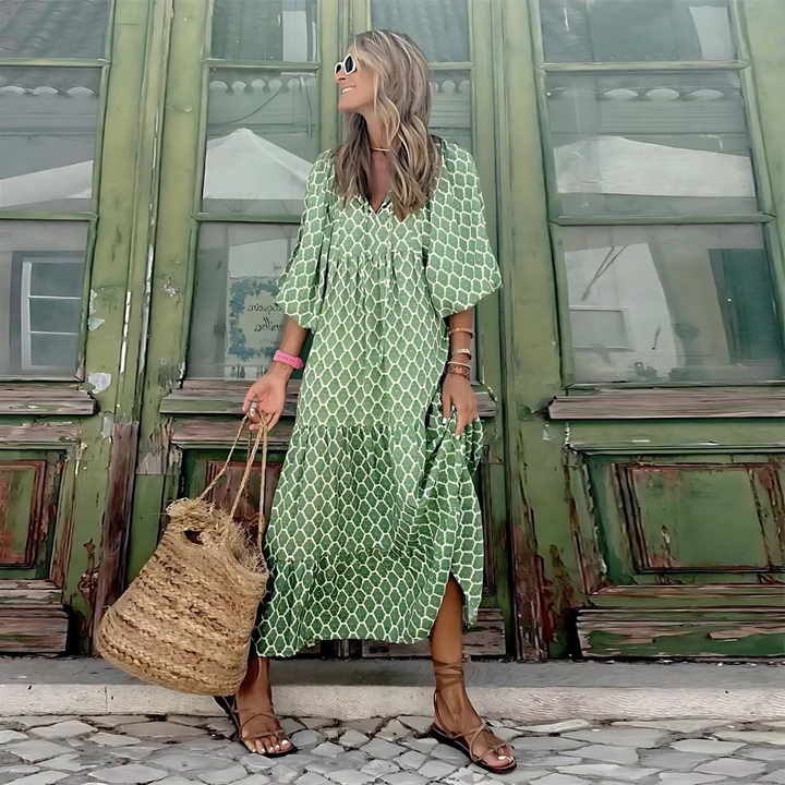A woman wearing the Concepta spring print dress in green and pink tones, styled for a day out.