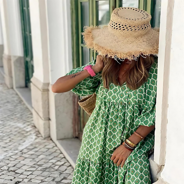 A woman wearing the Concepta spring print dress in green and pink tones, styled for a day out.