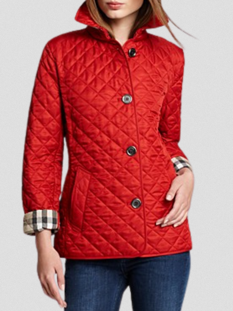 A woman wearing an autumn jacket over a top, layered for a crisp day in town.