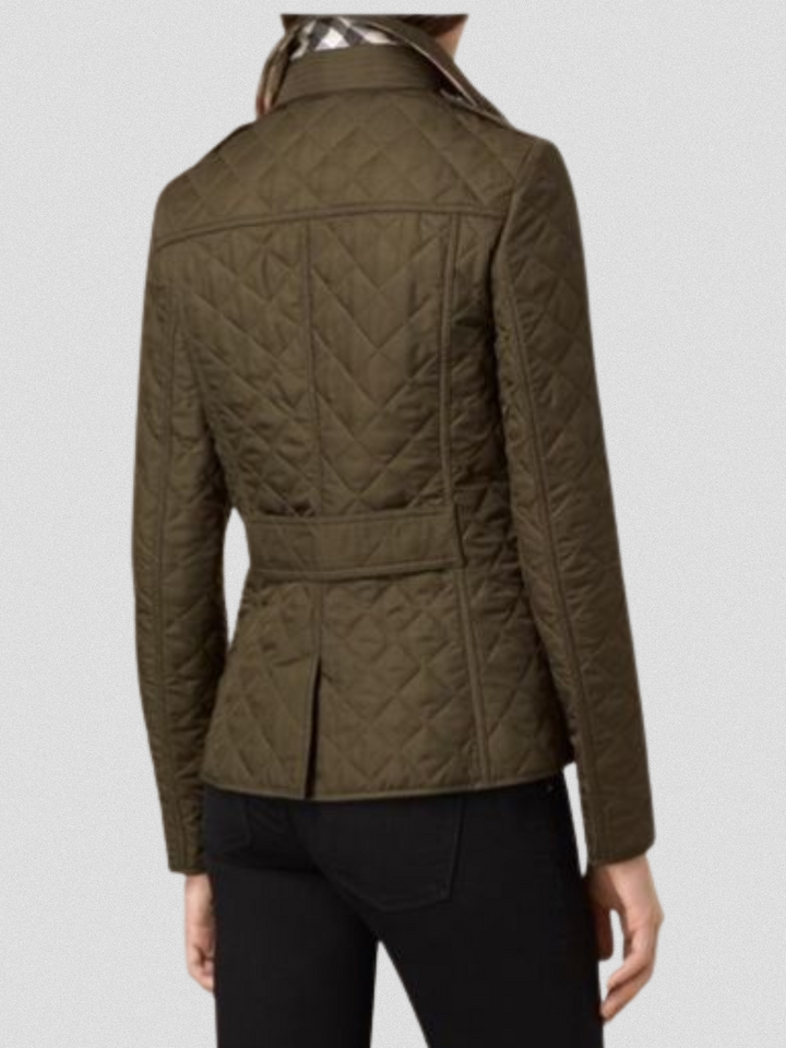 A woman wearing an autumn jacket over a top, layered for a crisp day in town.