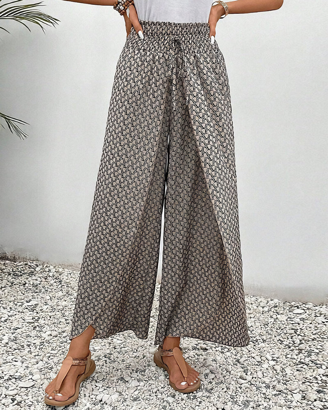 A woman wearing wide, flowing relaxed trousers with an elastic waist.