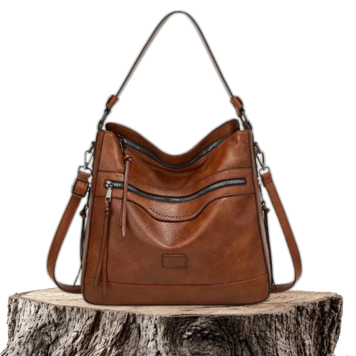 A woman carrying a structured brown everyday tote bag on her shoulder while out and about in town.