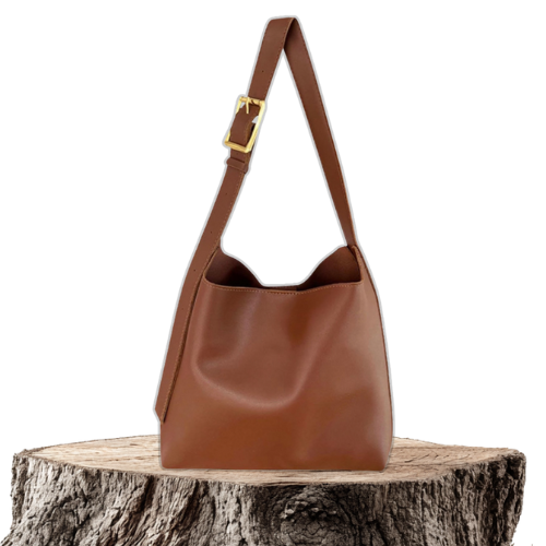 A woman carrying a classic structured handbag over her shoulder
