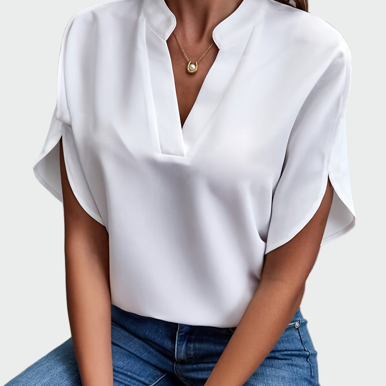 White women's V-neck blouse with a soft draped silhouette and short split-cuff sleeves