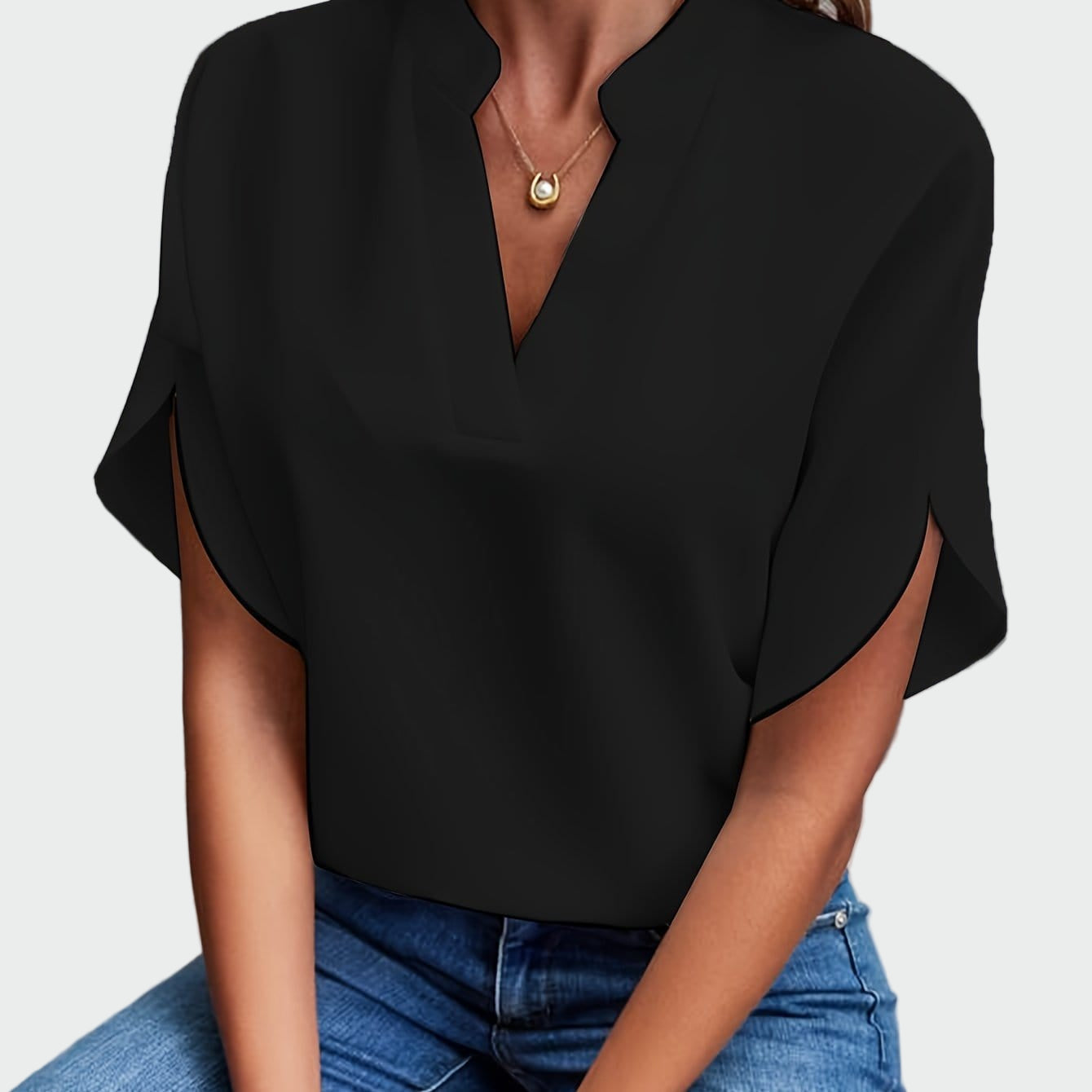 White women's V-neck blouse with a soft draped silhouette and short split-cuff sleeves