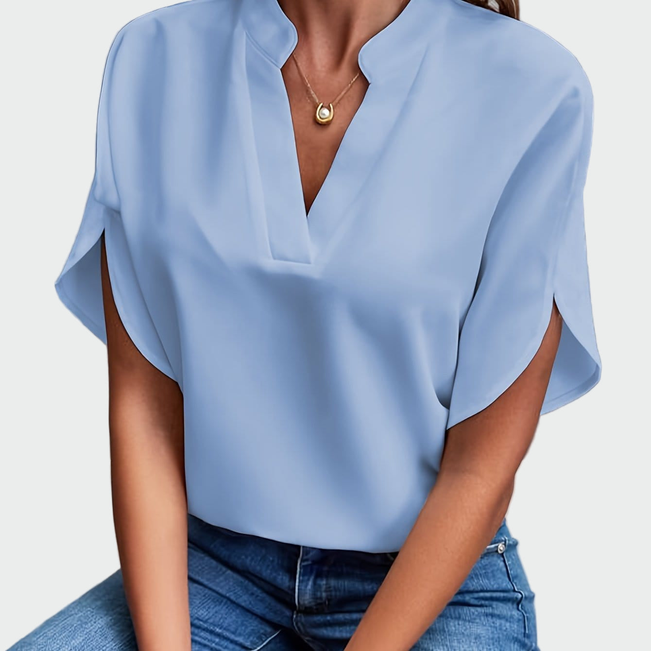 White women's V-neck blouse with a soft draped silhouette and short split-cuff sleeves