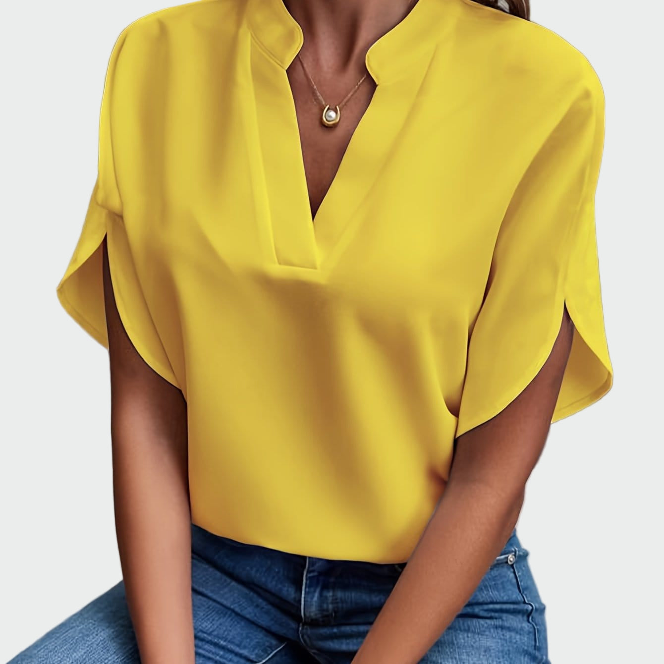 White women's V-neck blouse with a soft draped silhouette and short split-cuff sleeves