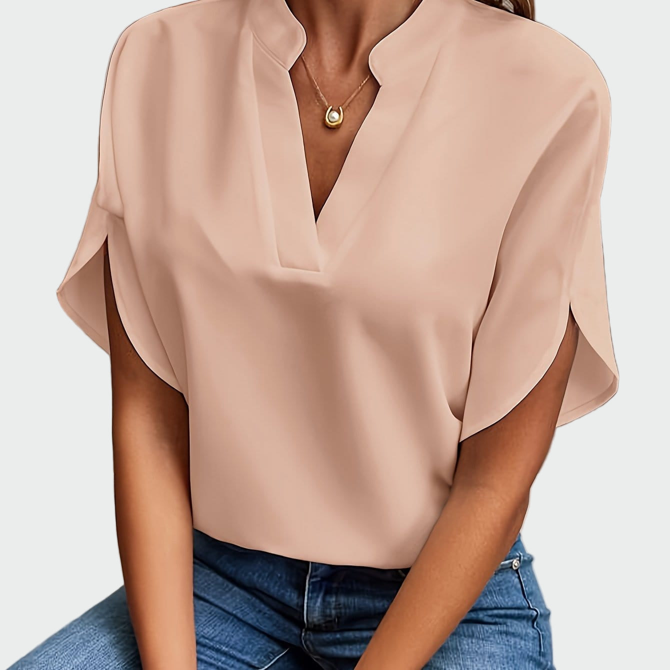 White women's V-neck blouse with a soft draped silhouette and short split-cuff sleeves