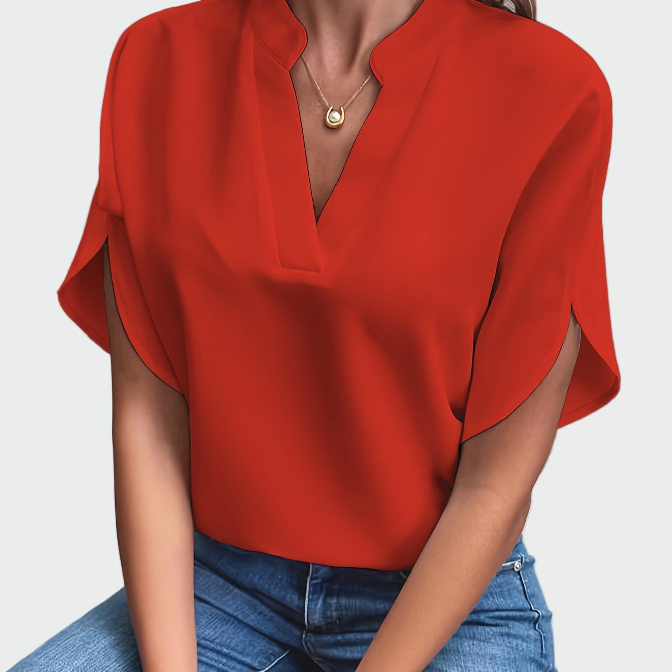 White women's V-neck blouse with a soft draped silhouette and short split-cuff sleeves