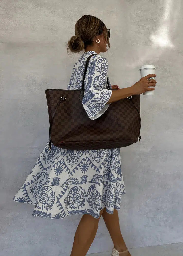 Woman wearing the Vivienne button-front boho tunic dress, relaxed on a casual day out.