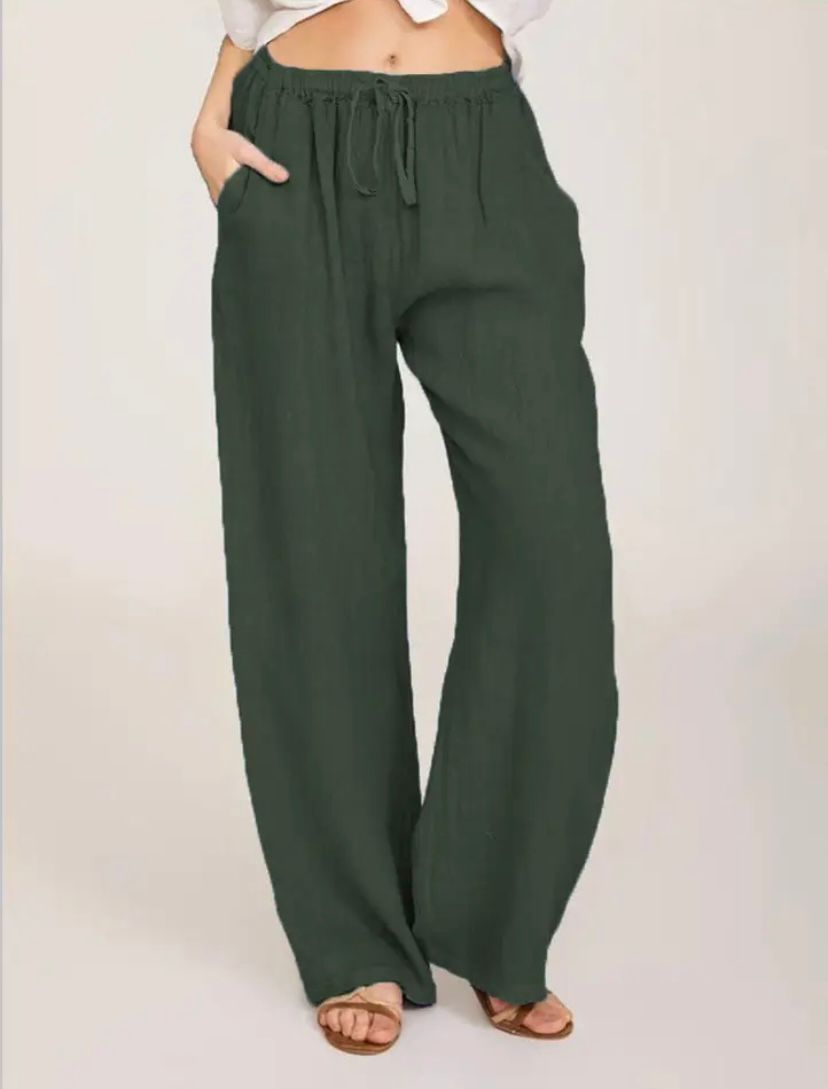 Woman wearing lightweight summer trousers with a light blouse, walking on a warm day.