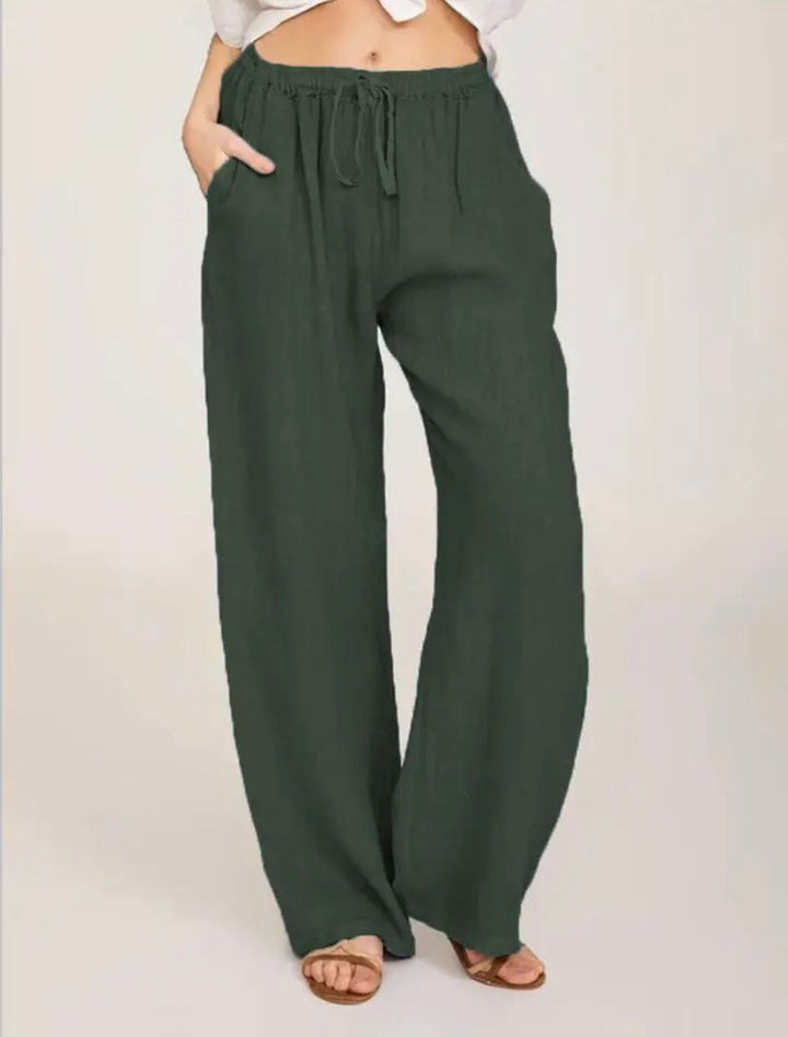 Woman wearing lightweight summer trousers with a light blouse, walking on a warm day.