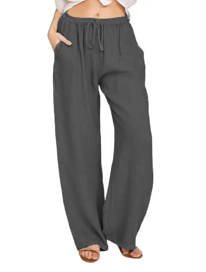 Woman wearing lightweight summer trousers with a light blouse, walking on a warm day.