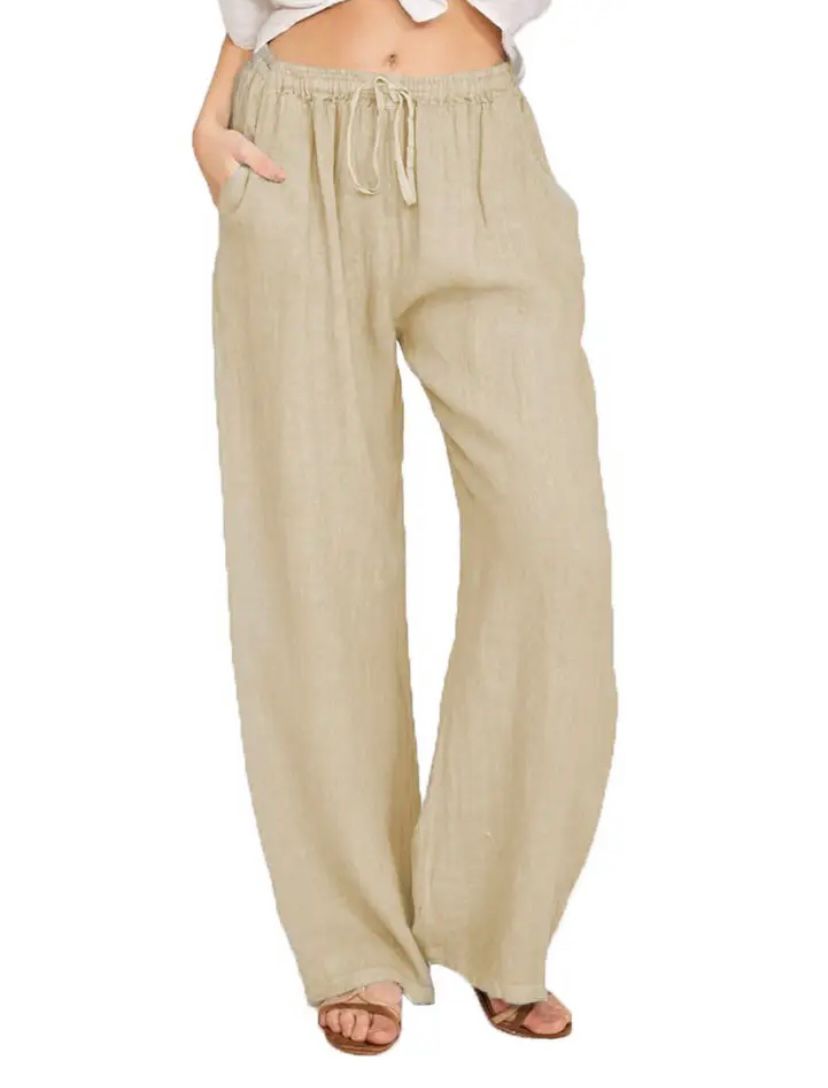 Woman wearing lightweight summer trousers with a light blouse, walking on a warm day.