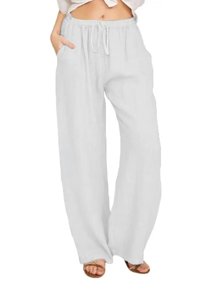 Woman wearing lightweight summer trousers with a light blouse, walking on a warm day.