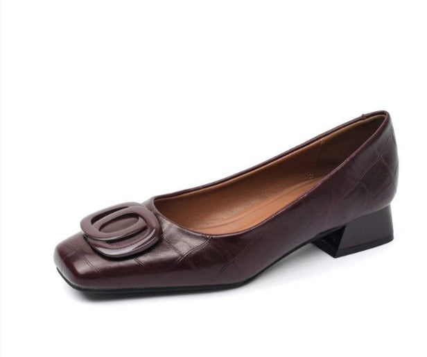 Low block heel shoes in brown, cream and black with a rounded toe and gold buckle detail