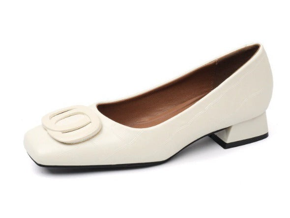 Low block heel shoes in brown, cream and black with a rounded toe and gold buckle detail