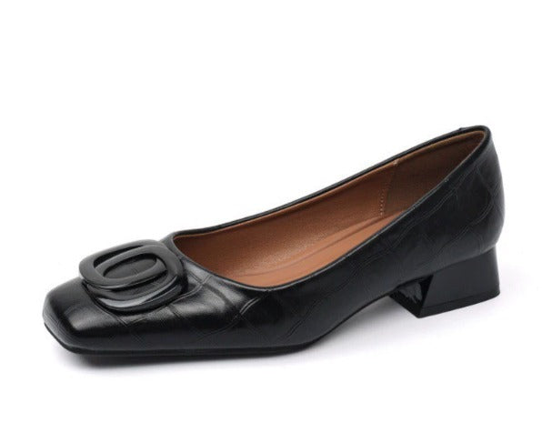 Low block heel shoes in brown, cream and black with a rounded toe and gold buckle detail