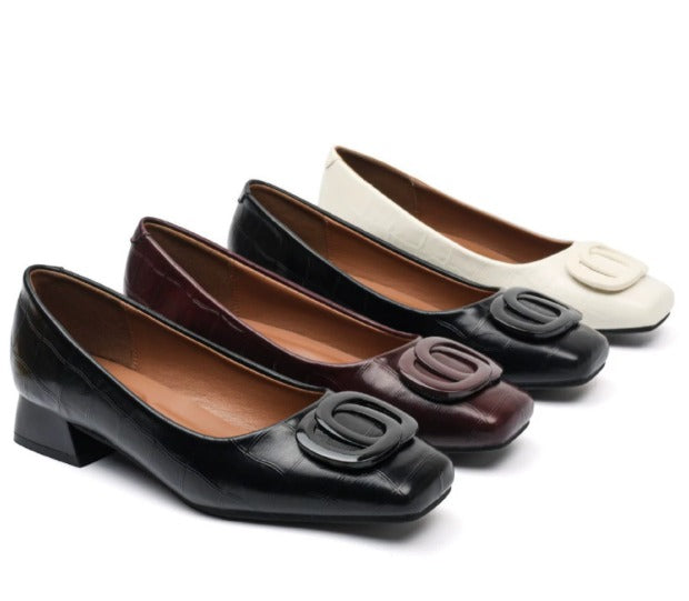 Low block heel shoes in brown, cream and black with a rounded toe and gold buckle detail