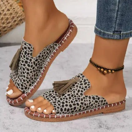 Flat boho sandals with colourful printed upper and swinging fringe detail