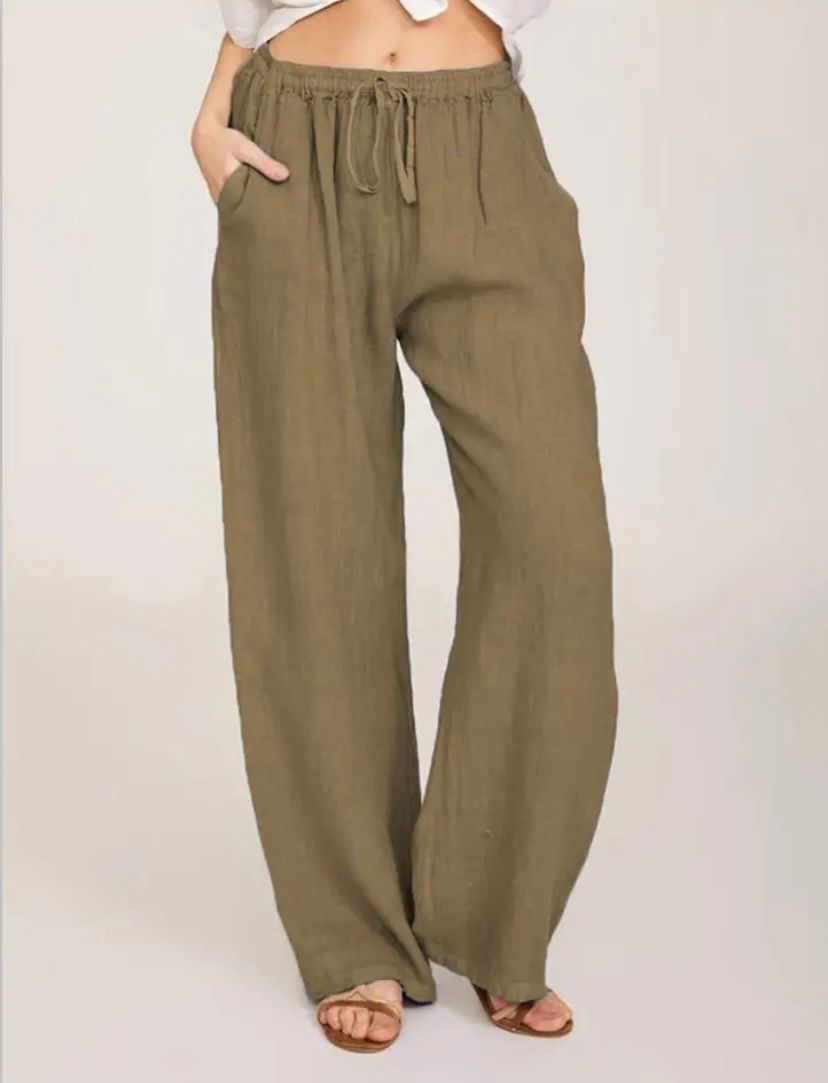 Woman wearing lightweight summer trousers with a light blouse, walking on a warm day.
