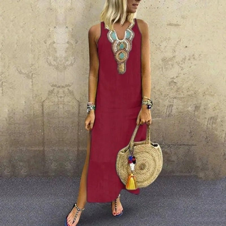 Woman in a sleeveless midi dress with embroidered neckline strolling in the summer sun.