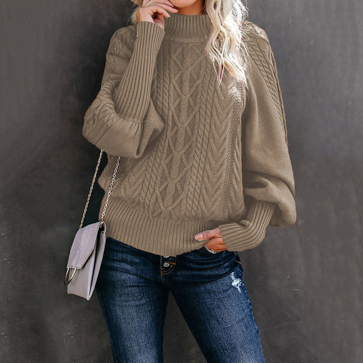 A woman wearing a long, relaxed jumper with long sleeves, soft and cosy for everyday wear.