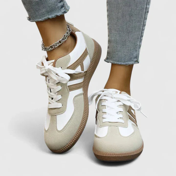 A woman wearing orthopaedic shoes with a supportive heel and a subtle lift
