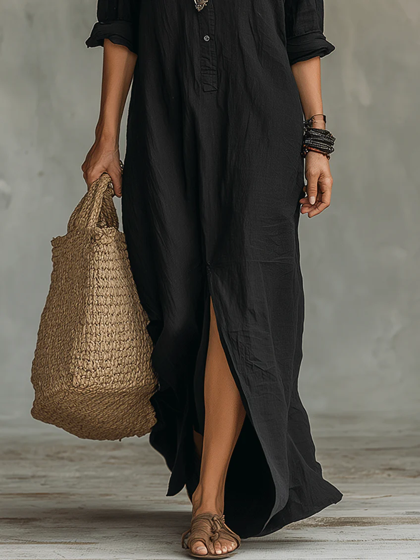 Elegant floaty maxi dress in black with a flowing full-length silhouette and structured bodice