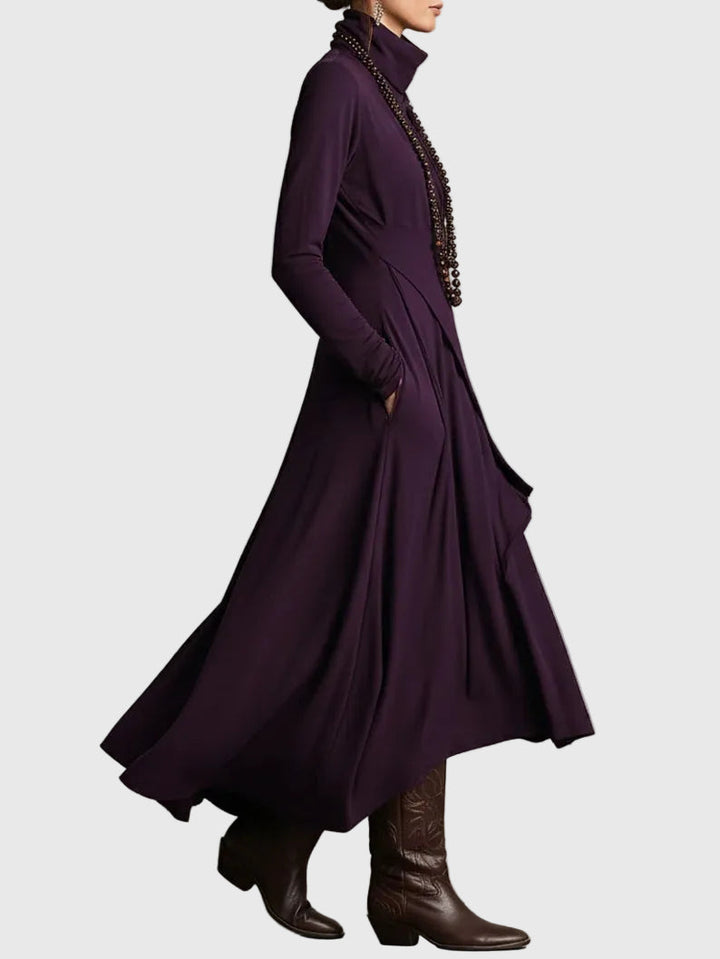 Woman wearing the Lucy draped high-neck maxi dress in violet with ankle boots.