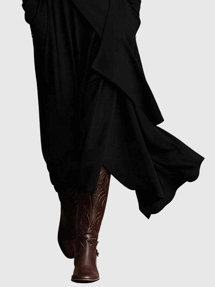 Woman wearing the Lucy draped high-neck maxi dress in violet with ankle boots.