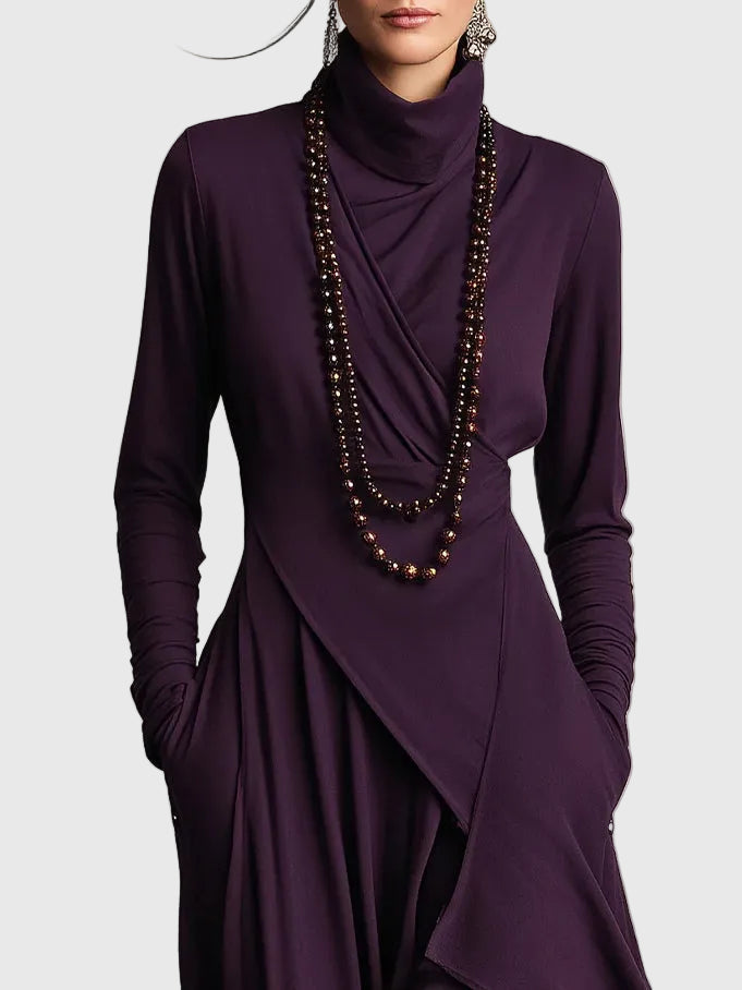 Woman wearing the Lucy draped high-neck maxi dress in violet with ankle boots.