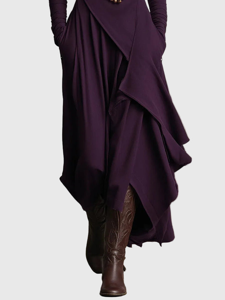 Woman wearing the Lucy draped high-neck maxi dress in violet with ankle boots.