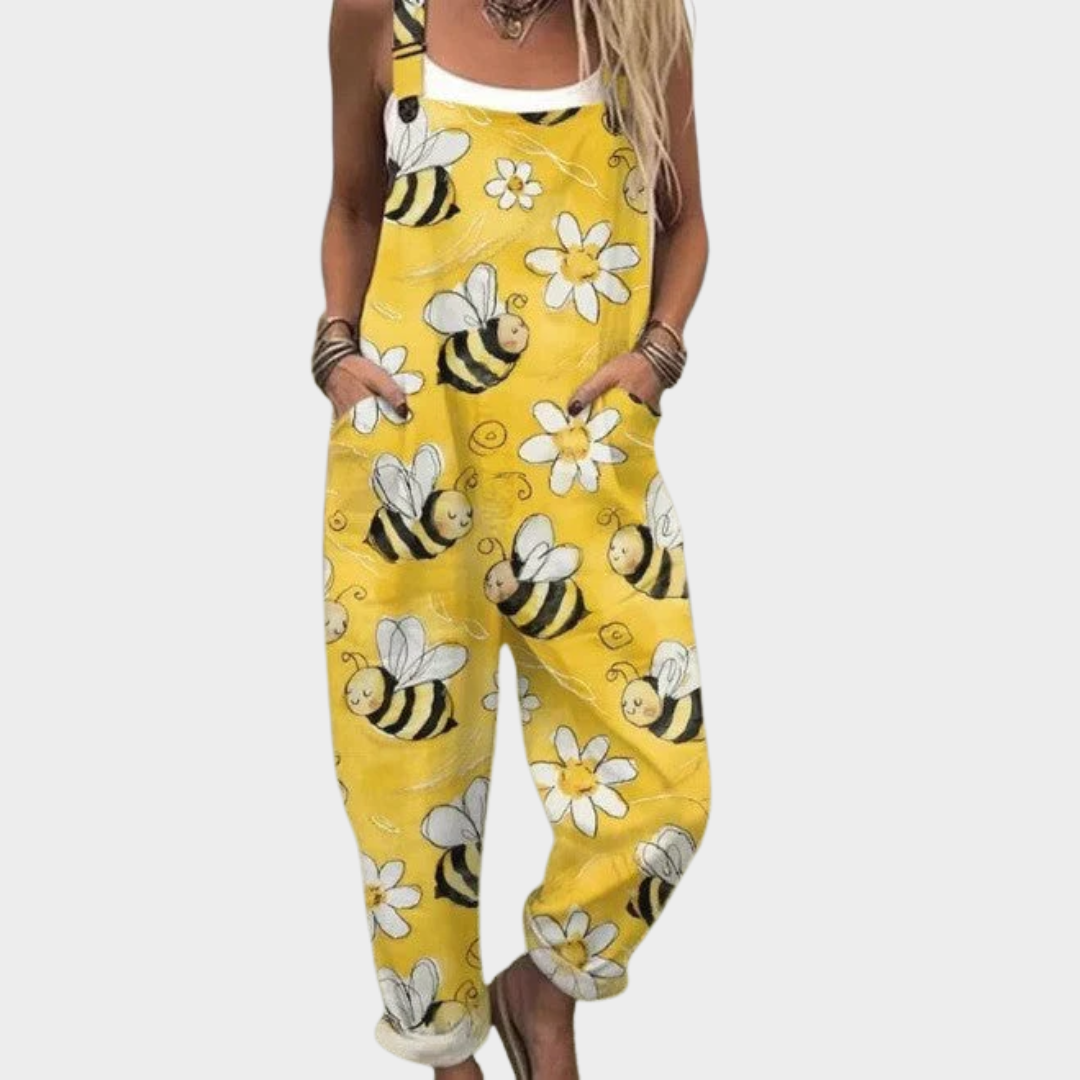 Woman wearing sunny yellow dungarees printed with little bees and white daisies
