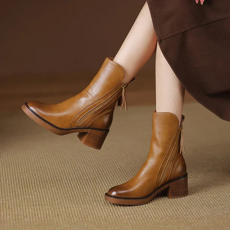 A pair of classic black ankle boots with a sturdy block heel and side zip fastening