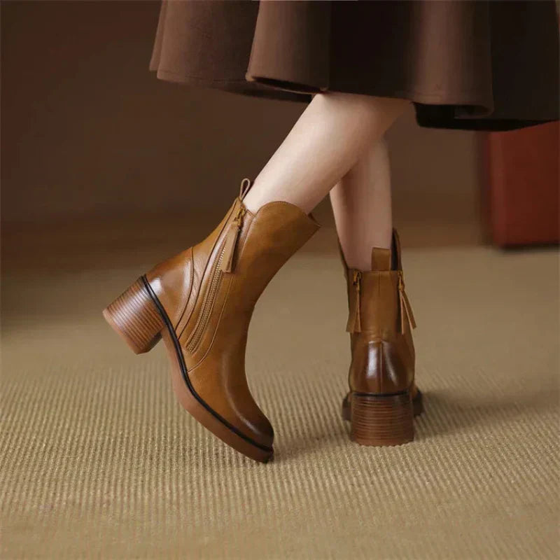 A pair of classic black ankle boots with a sturdy block heel and side zip fastening