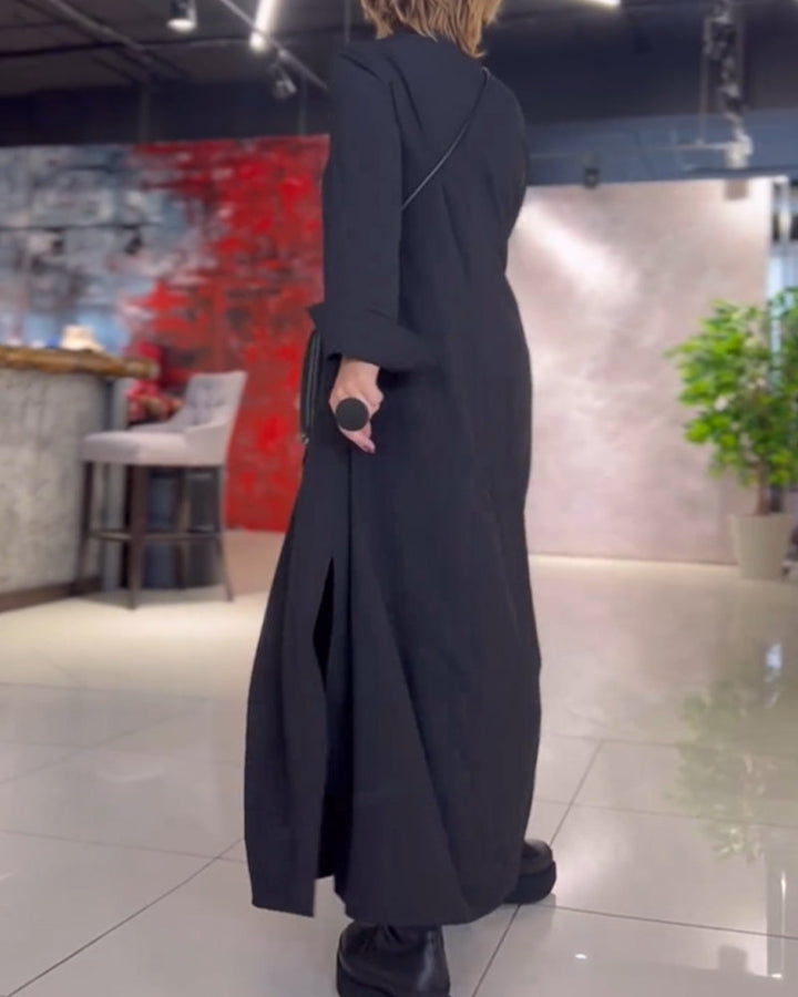 Woman wearing the Sarah relaxed maxi dress with revere collar, standing by a doorway.