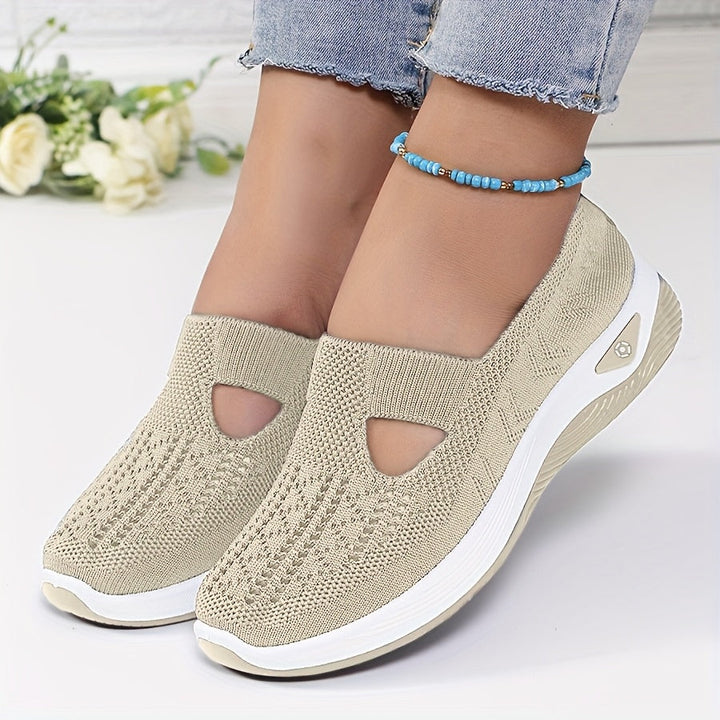 A woman stepping into easy slip-on comfort trainers with no laces.