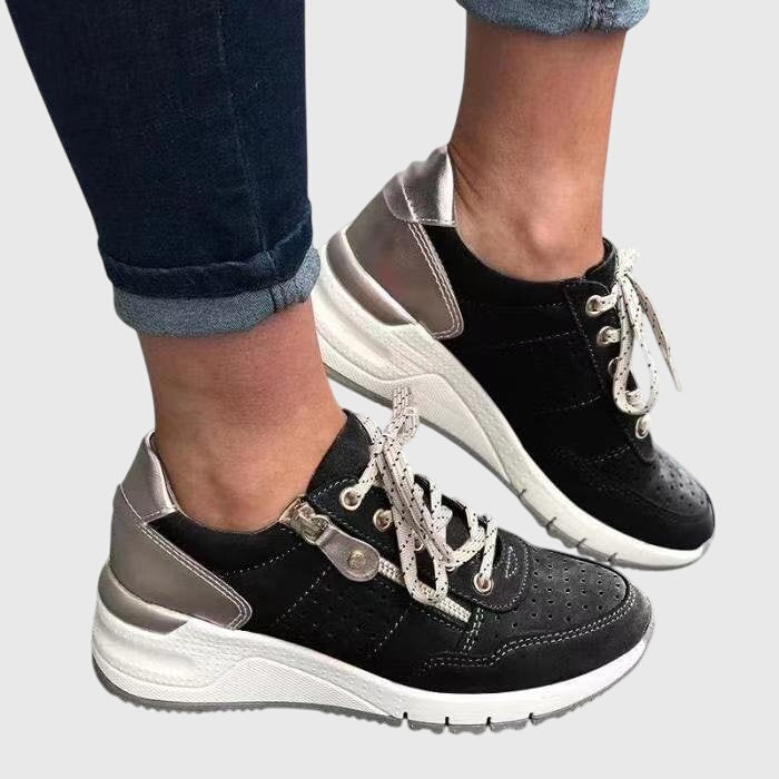 A woman on a walk wearing soft, supportive trainers on a bright day.
