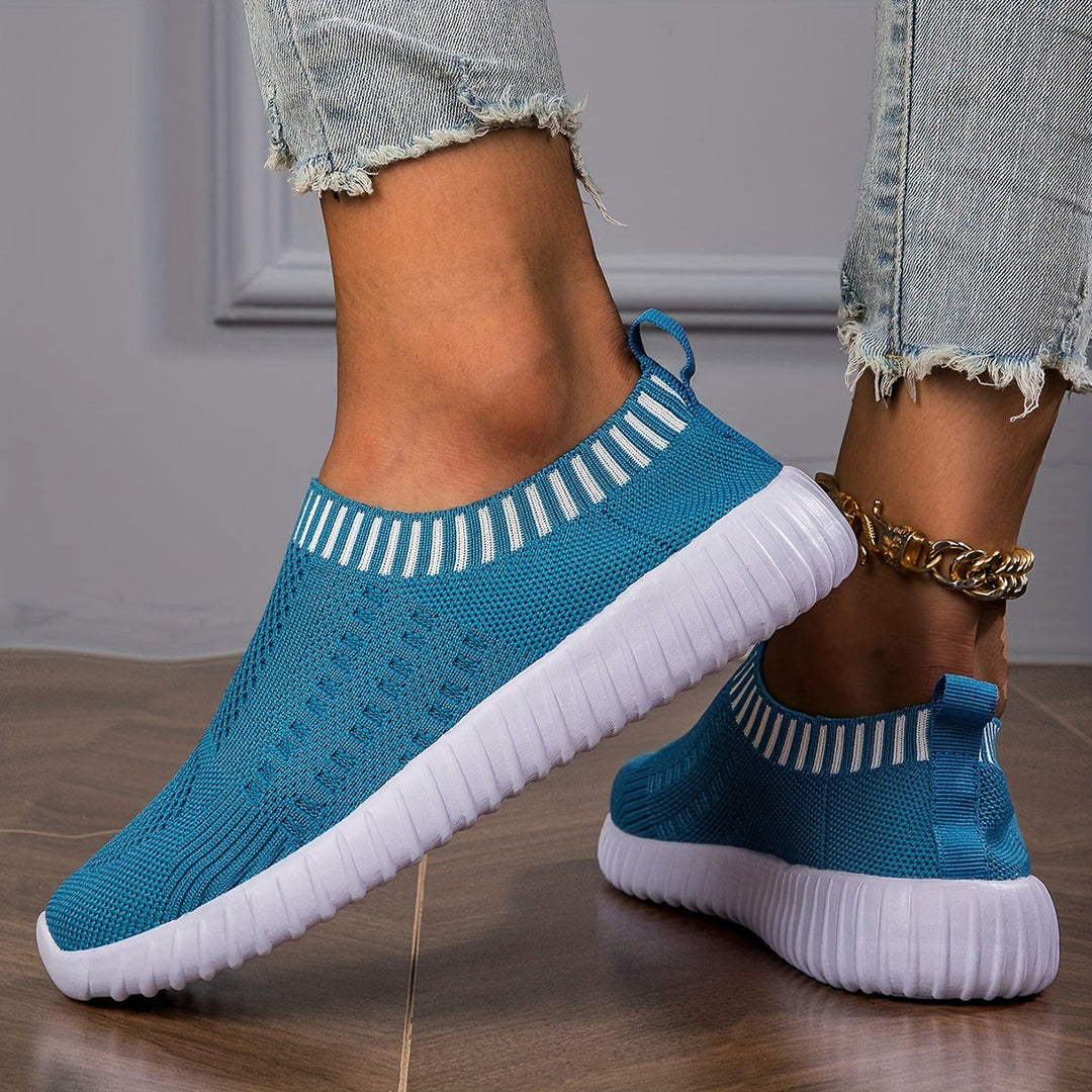 A woman slipping on ultralight sock-style trainers that hug the foot.