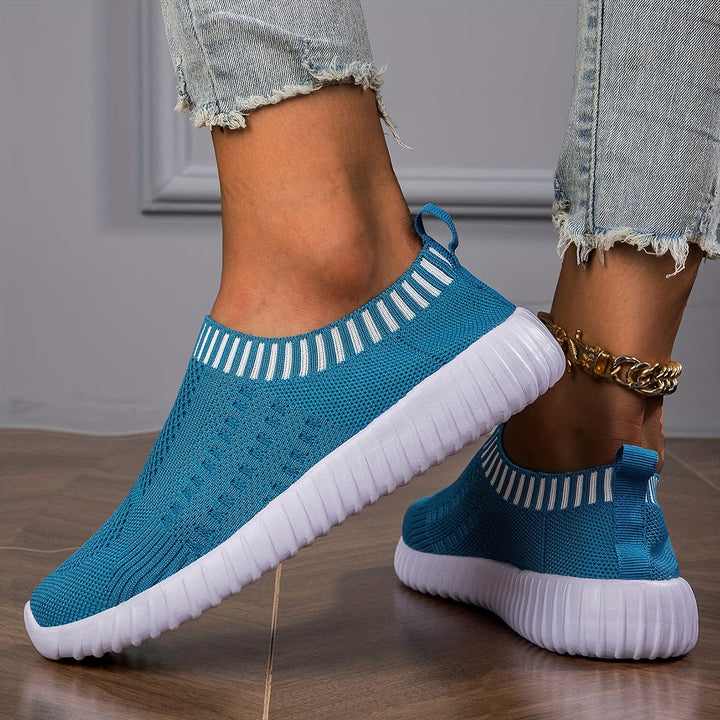 A woman slipping on ultralight sock-style trainers that hug the foot.