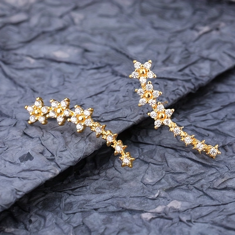 Rose gold floral crawler earrings with delicate sparkling floral motif following the curve of the ear